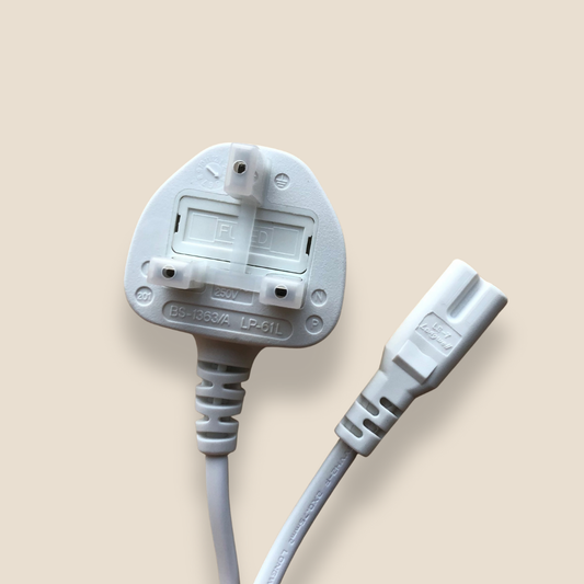 White electrical power cable with UK plug on a beige background