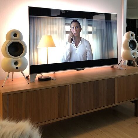 Scandyna TV Pack white placed on furniture in walnut, TV shows Blockbuster movie James Bond starring Daniel Craig